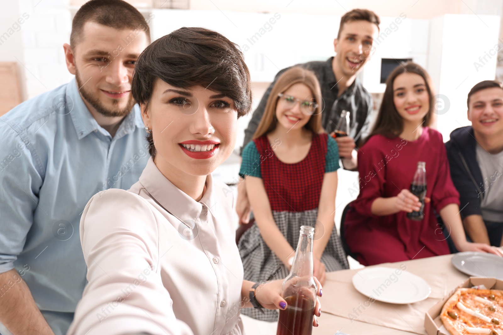 Photo of Happy friends taking selfie indoors