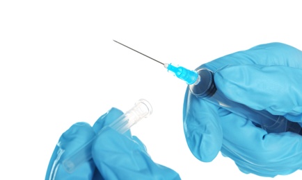Photo of Doctor in medical gloves holding syringe on white background