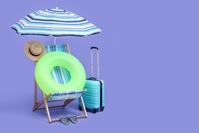 Photo of Deck chair, suitcase and beach accessories on purple background, space for text. Summer vacation