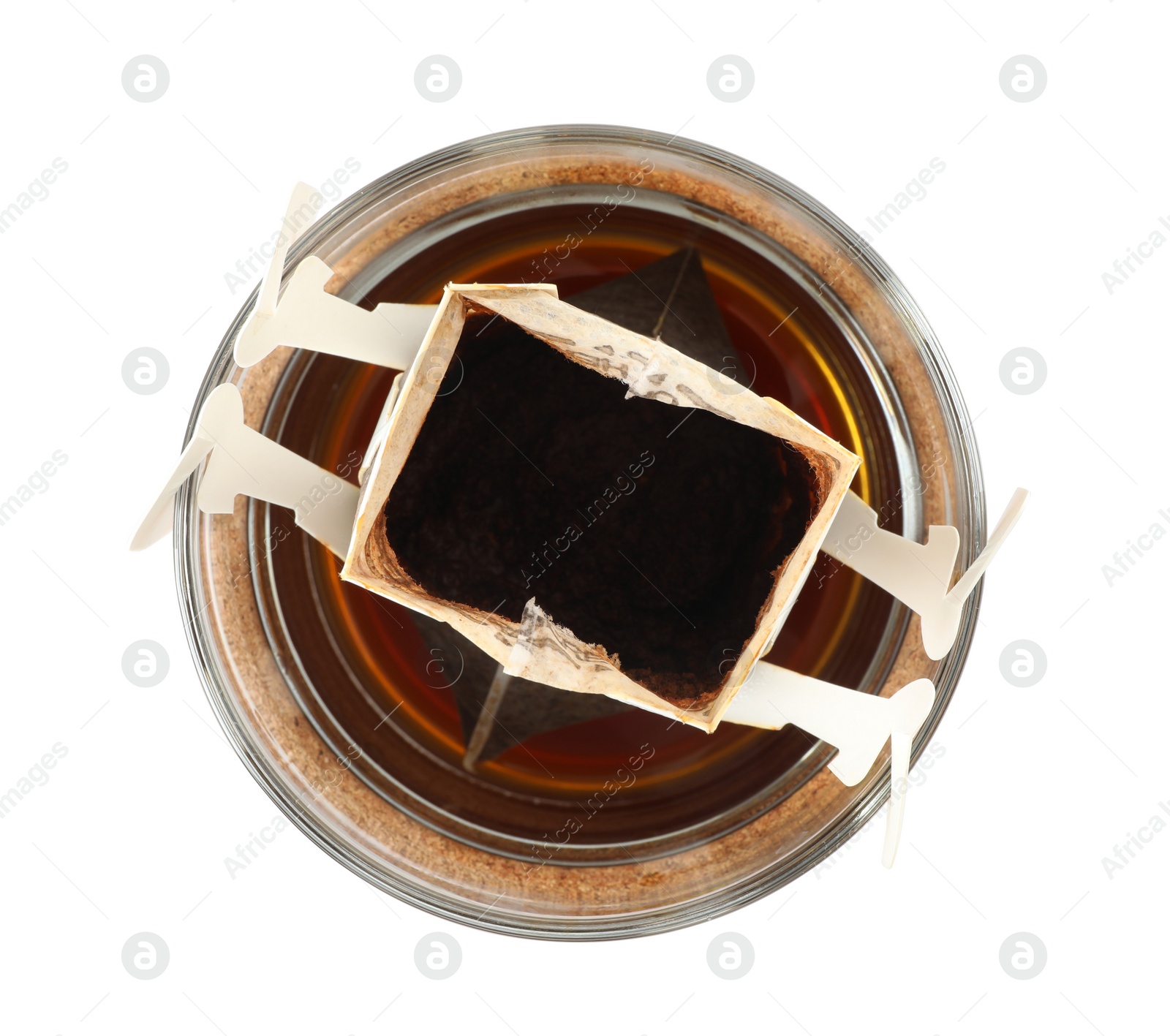 Photo of Glass cup with drip coffee bag isolated on white, top view