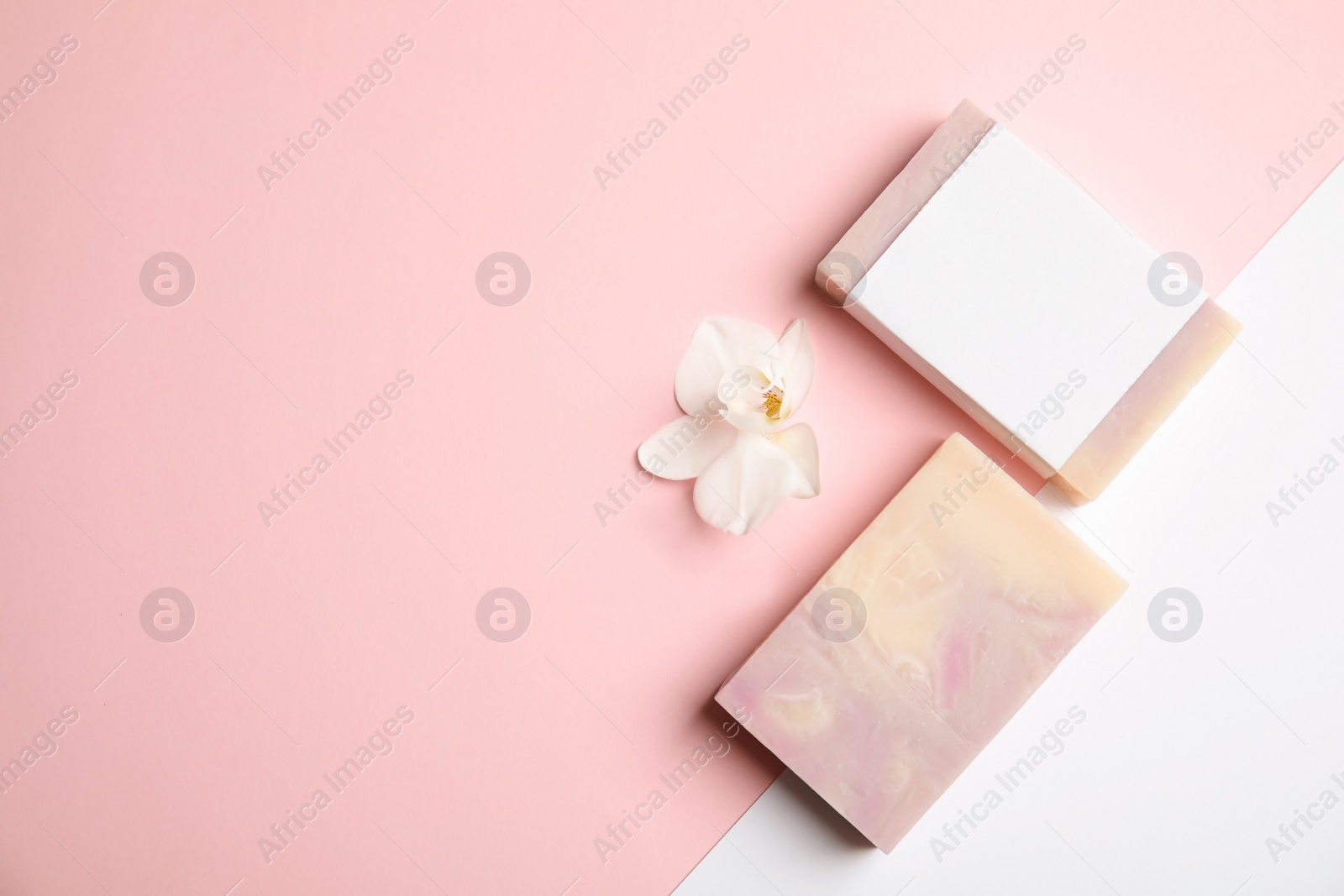 Photo of Flat lay composition with handmade soap bars on color background. Space for text