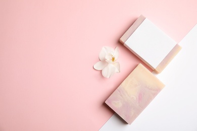 Flat lay composition with handmade soap bars on color background. Space for text