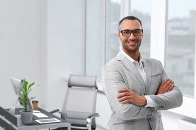 Photo of Smiling young businessman in office. Space for text