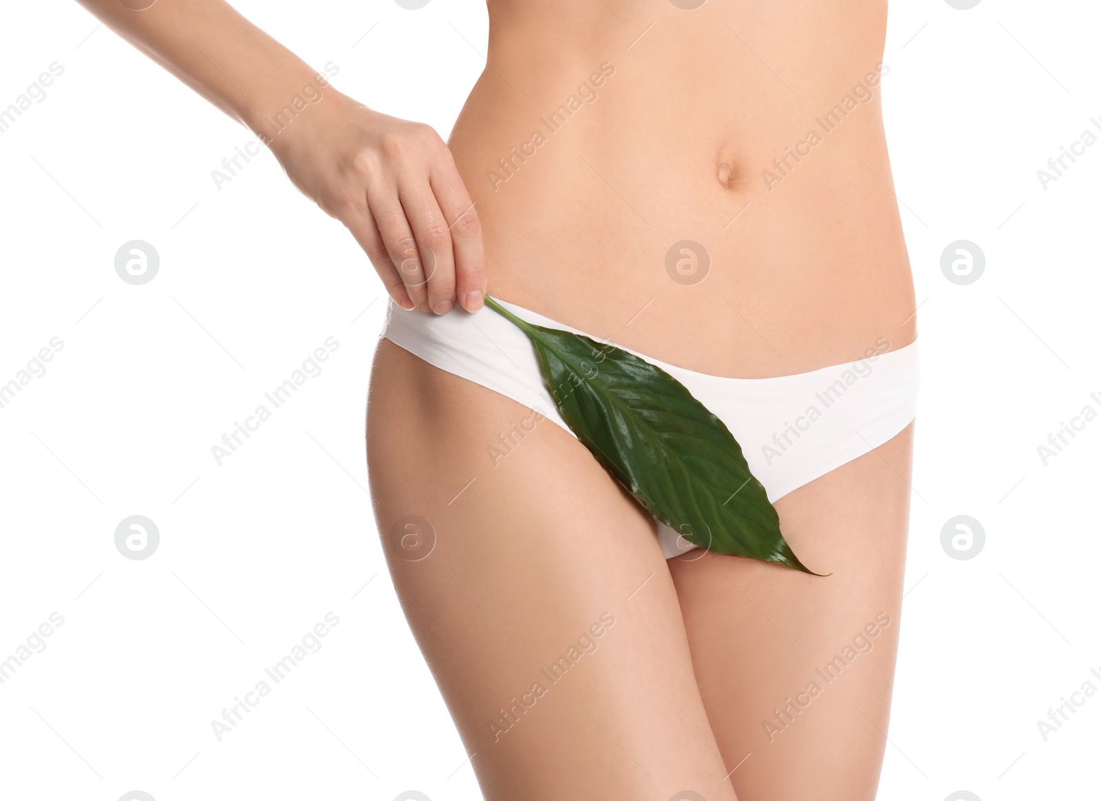 Photo of Woman with leaf showing smooth skin after bikini epilation on white background, closeup. Body care concept