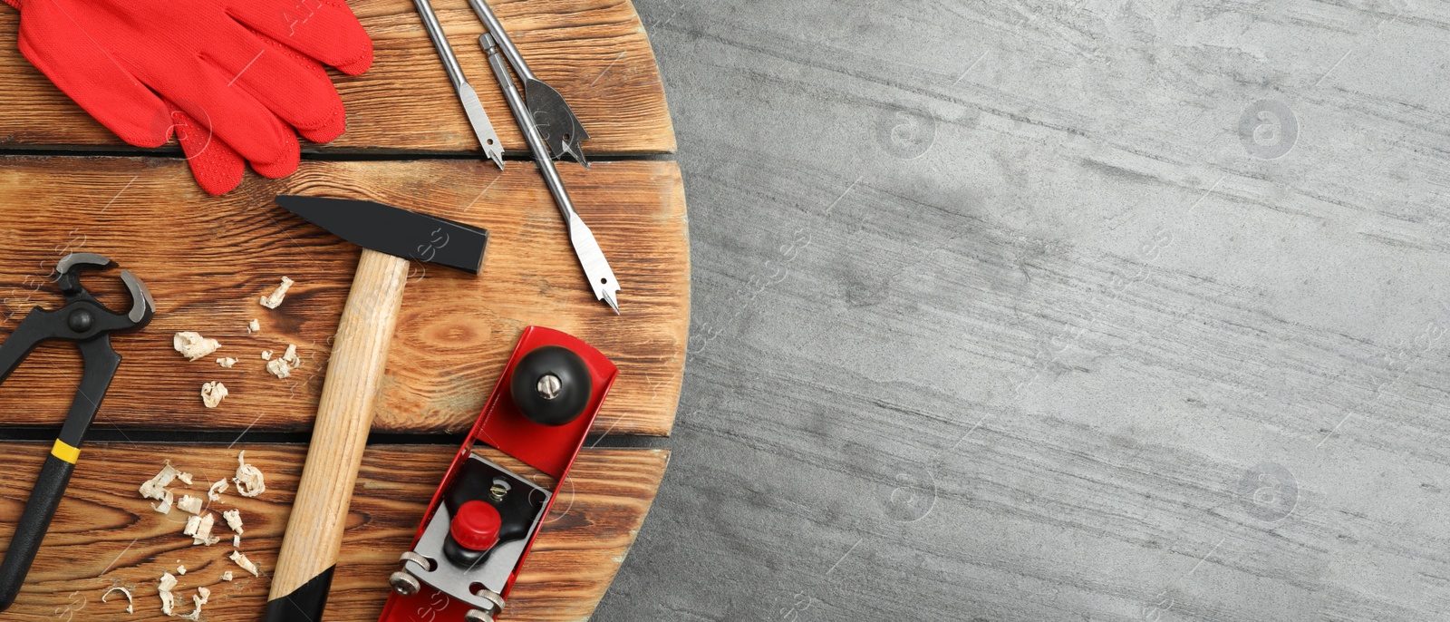 Image of Different carpenter's tools on grey stone background, flat lay with space for text. Banner design