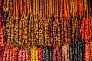 Photo of Bunches of different delicious churchkhelas at market