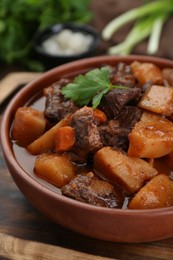 Delicious beef stew with carrots, parsley and potatoes, closeup