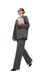 Beautiful businesswoman in suit with tablet walking on white background