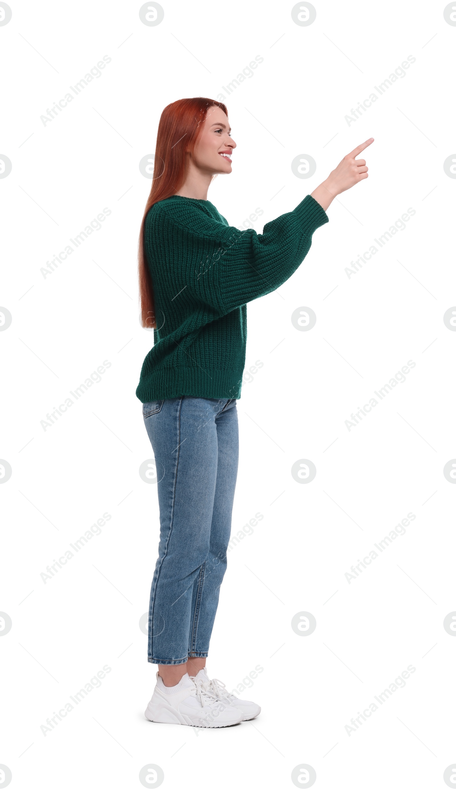 Photo of Happy woman pointing at something on white background