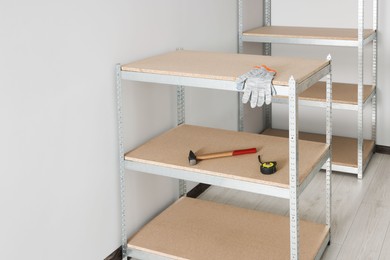 Metal storage shelf with room renovation tools in office