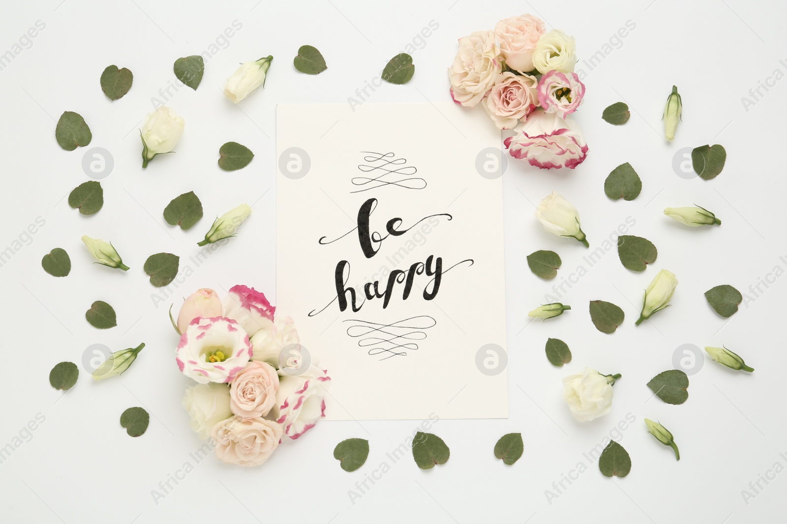 Photo of Frame of beautiful flowers and paper card with handwritten text Be happy on white background, flat lay