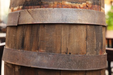 Photo of Traditional wooden barrel outdoors, closeup. Wine making