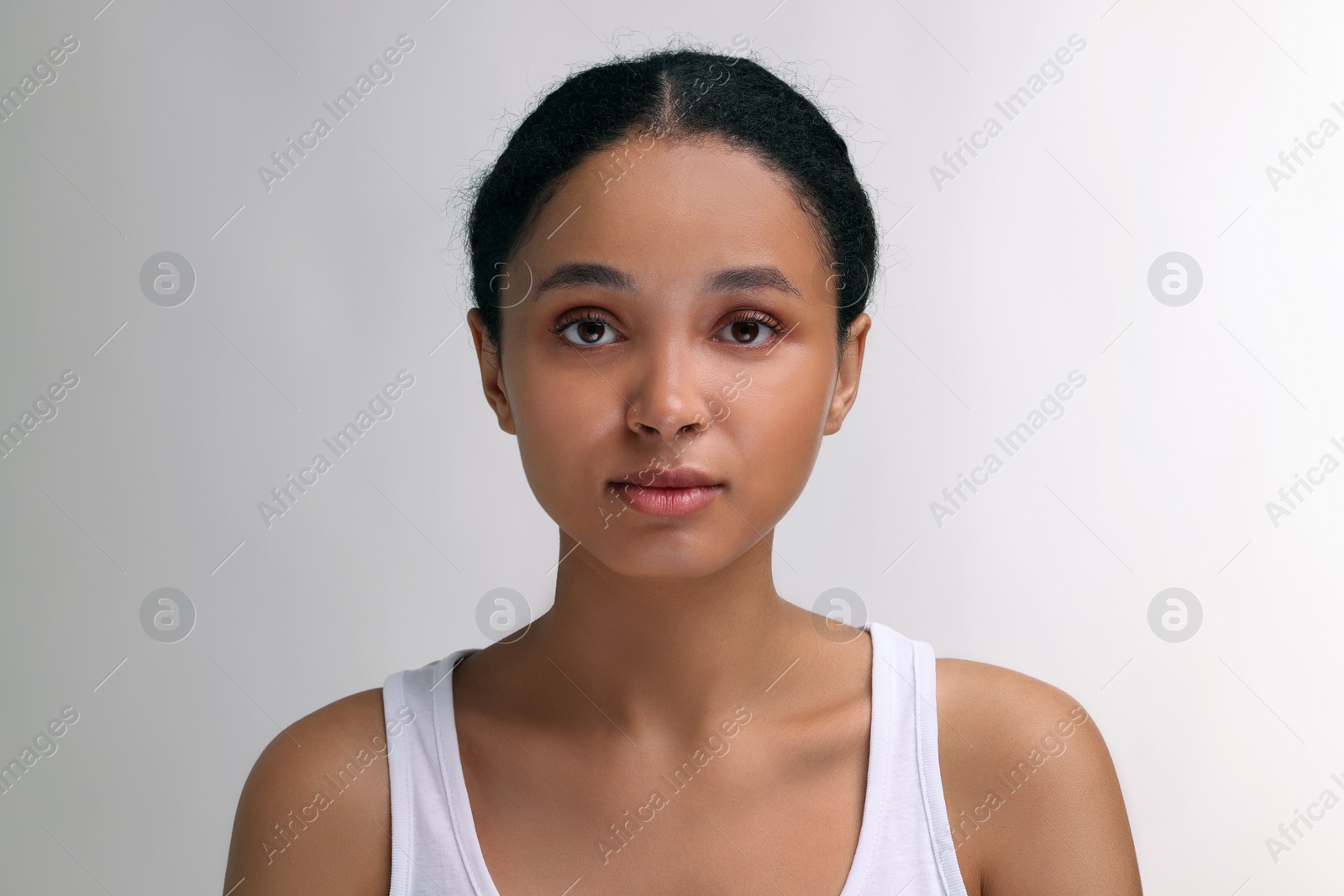 Photo of Portrait of beautiful woman looking at camera on light background