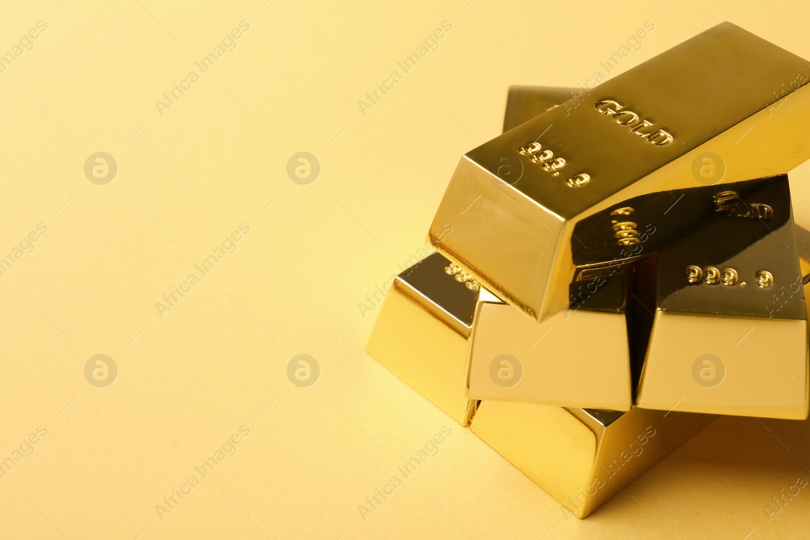 Photo of Shiny gold bars on color background. Space for text