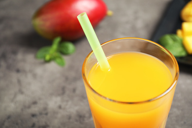 Fresh delicious mango drink on table, closeup