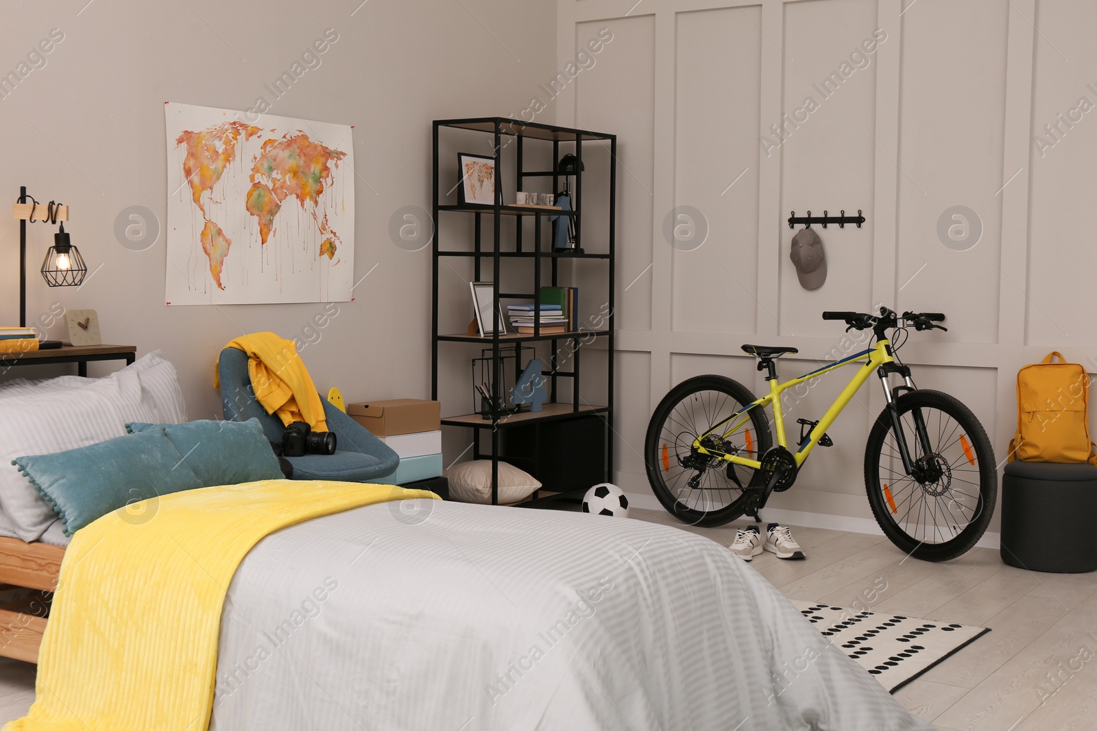 Photo of Stylish teenager's room interior with comfortable bed and sports equipment