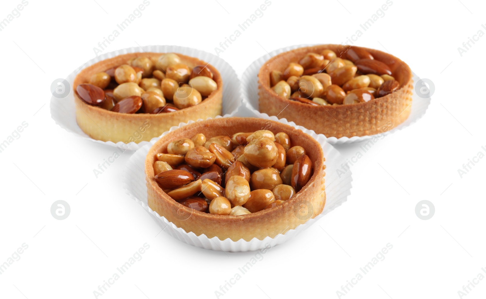 Photo of Tartlets with caramelized nuts isolated on white. Tasty dessert