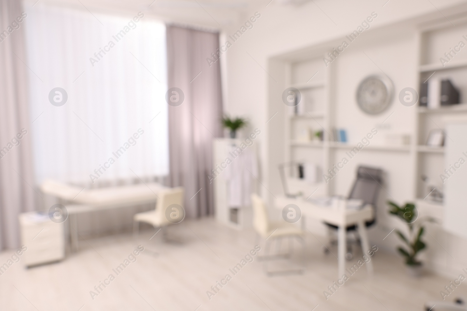 Photo of Blurred view of medical office interior with doctor's workplace