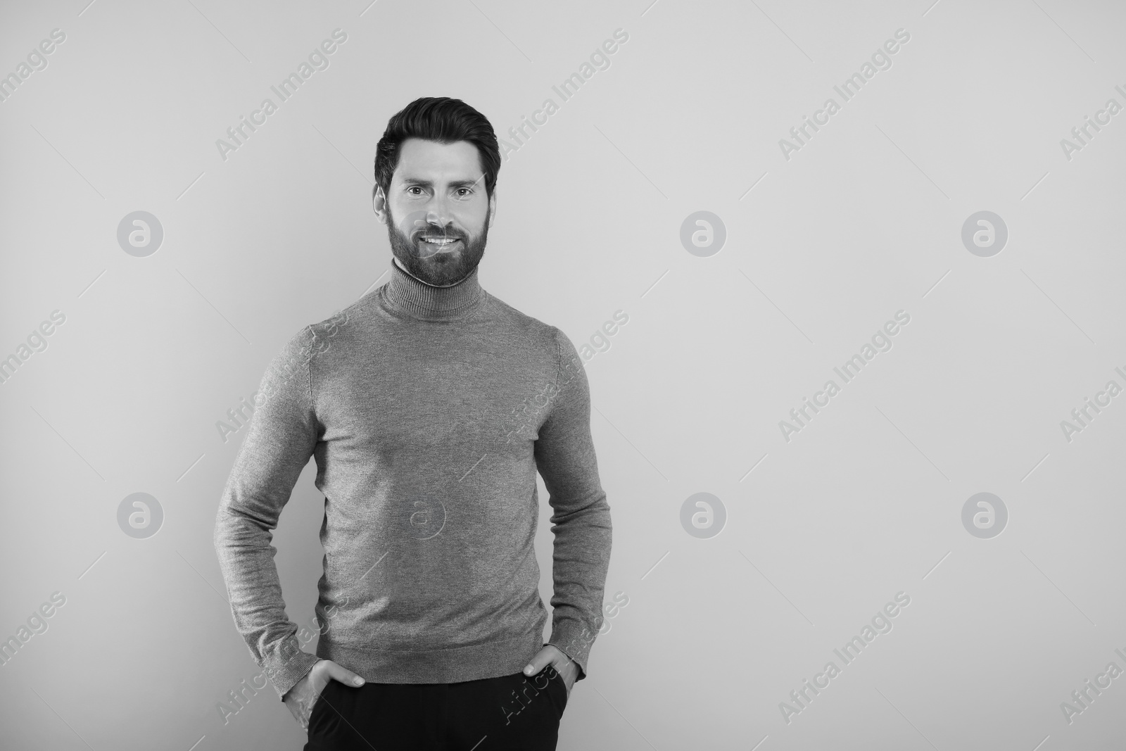 Image of Portrait of handsome man on light background, space for text. Black and white effect