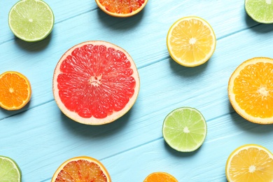 Flat lay composition with different citrus fruits on wooden background