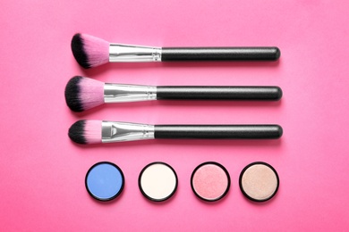 Flat lay composition with products for decorative makeup on pink background