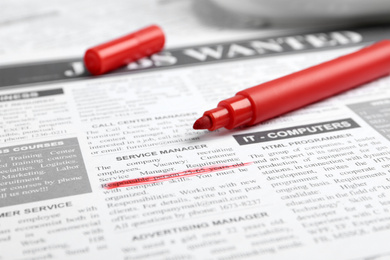 Photo of Red marker on newspaper. Job search concept