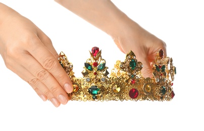 Woman holding beautiful golden crown on white background, closeup. Fantasy item
