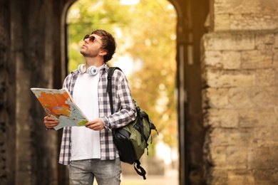 Photo of Traveler with world map on city street