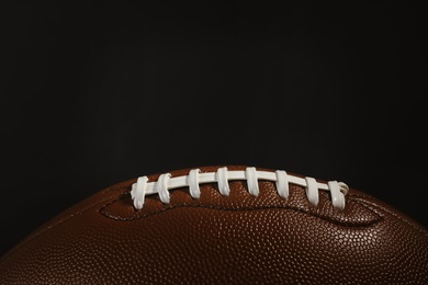 Photo of New American football ball on dark background