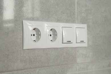 Light switches and power sockets on wall indoors