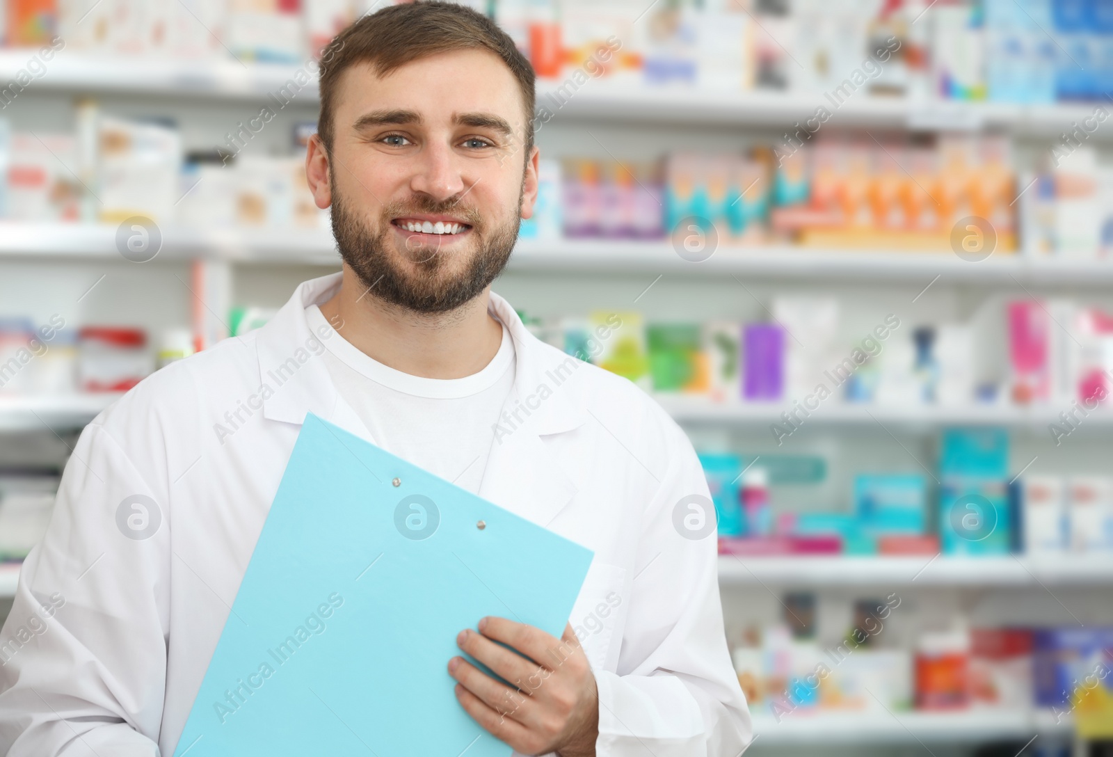 Image of Professional pharmacist with clipboard in modern drugstore