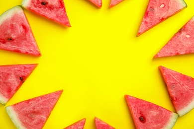 Photo of Frame made with slices of ripe watermelon on yellow background, flat lay. Space for text