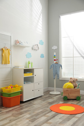 Modern baby room interior with stylish furniture