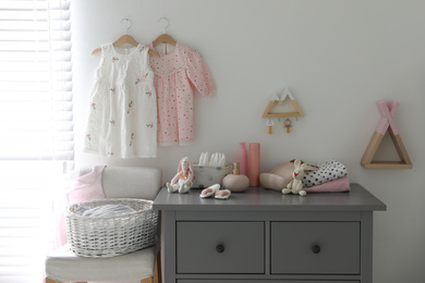 Photo of Stylish chest of drawers and accessories in child room