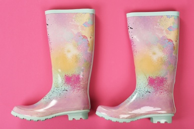 Photo of Pair of gumboots on color background, top view. Female shoes