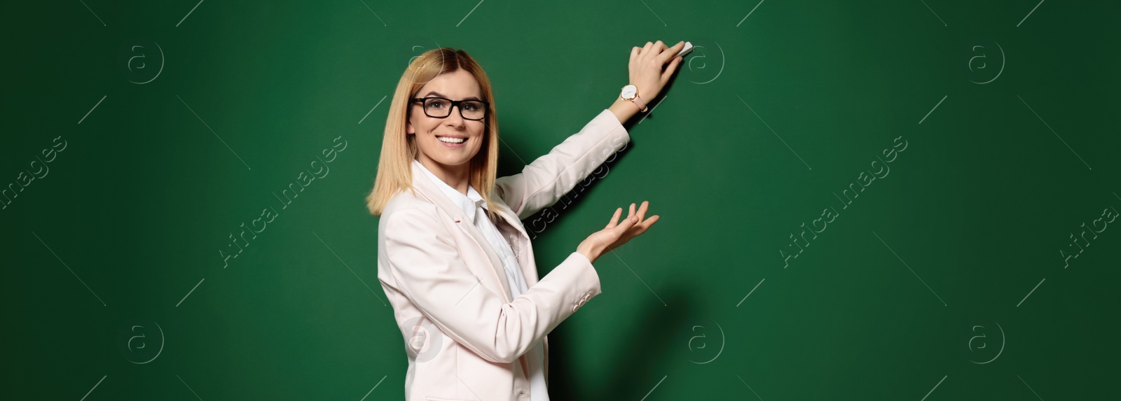 Image of Beautiful teacher writing on chalkboard. Banner design