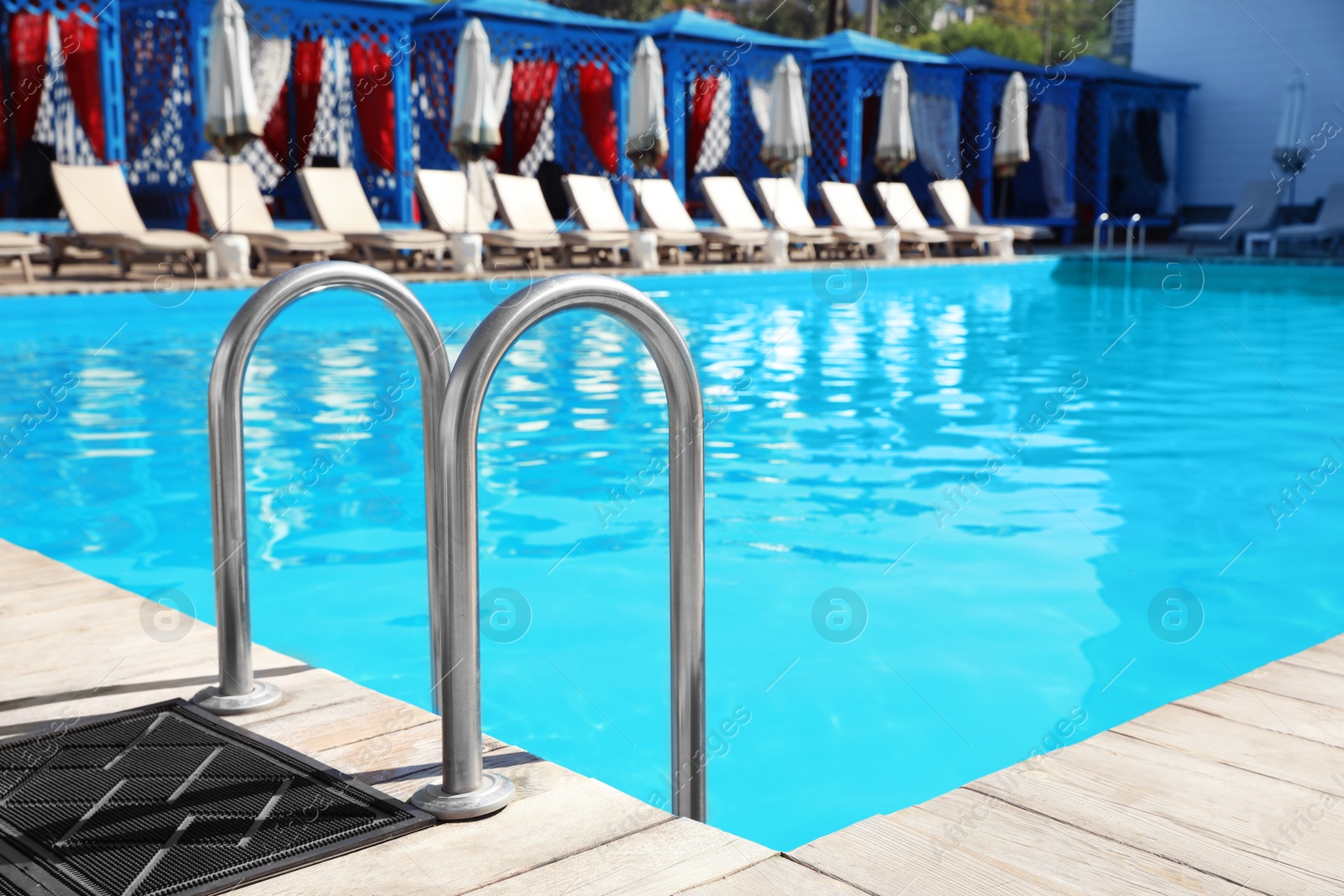 Photo of Modern swimming pool with step ladder outdoors