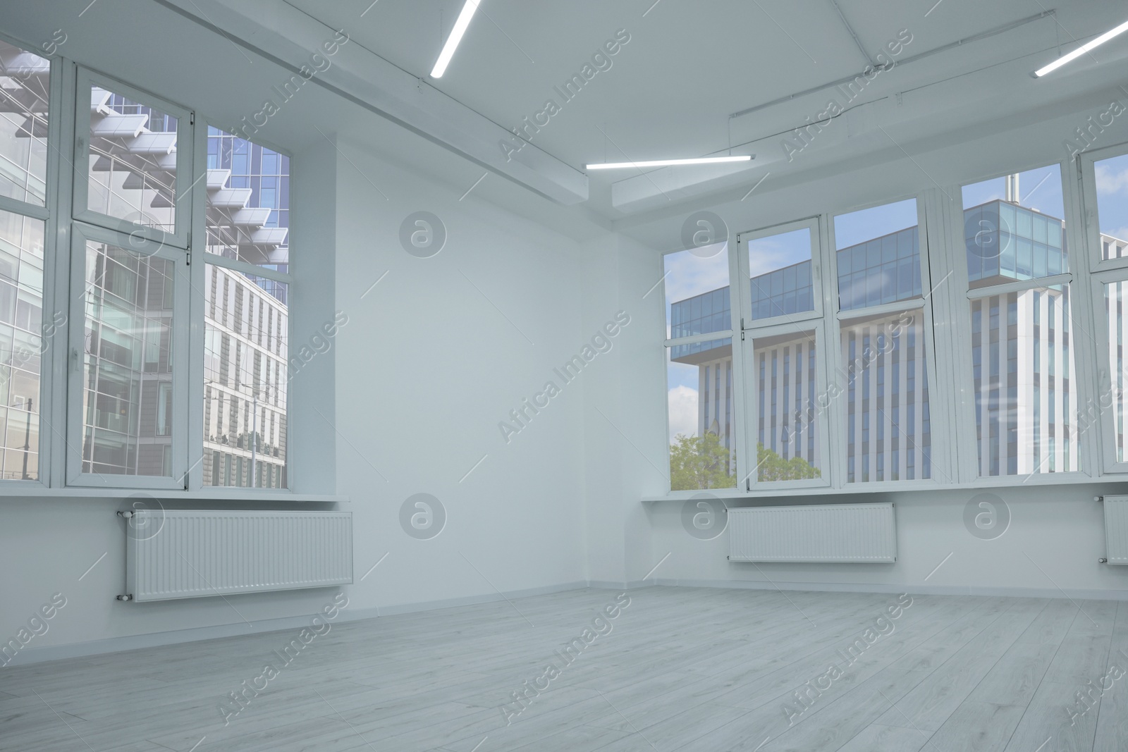 Photo of New empty room with clean windows and white walls