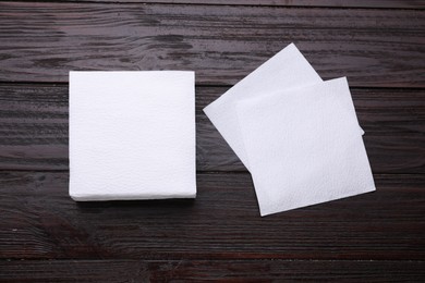 Photo of Clean paper tissues on wooden table, flat lay