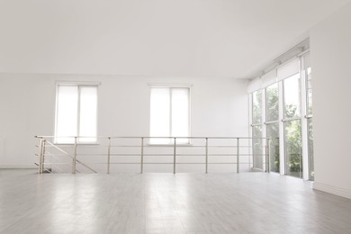 Photo of Empty room with windows and laminated floor