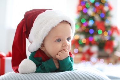 Photo of Cute baby in Christmas costume at home