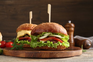 Photo of Delicious vegetarian burgers served on wooden table