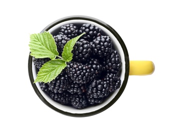 Photo of Mug with ripe blackberries on white background, top view