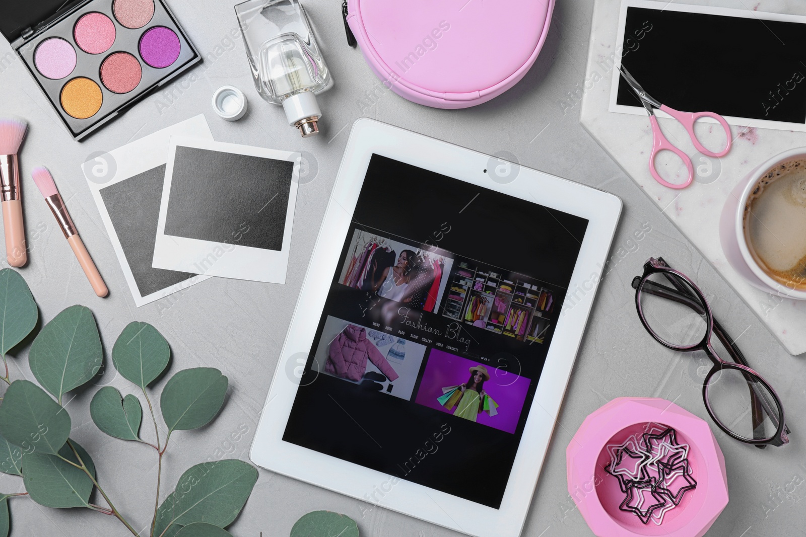 Photo of Flat lay composition with tablet and fashion blogger's stuff on stone surface