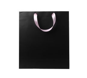 Paper shopping bag with ribbon handles on white background. Mockup for design