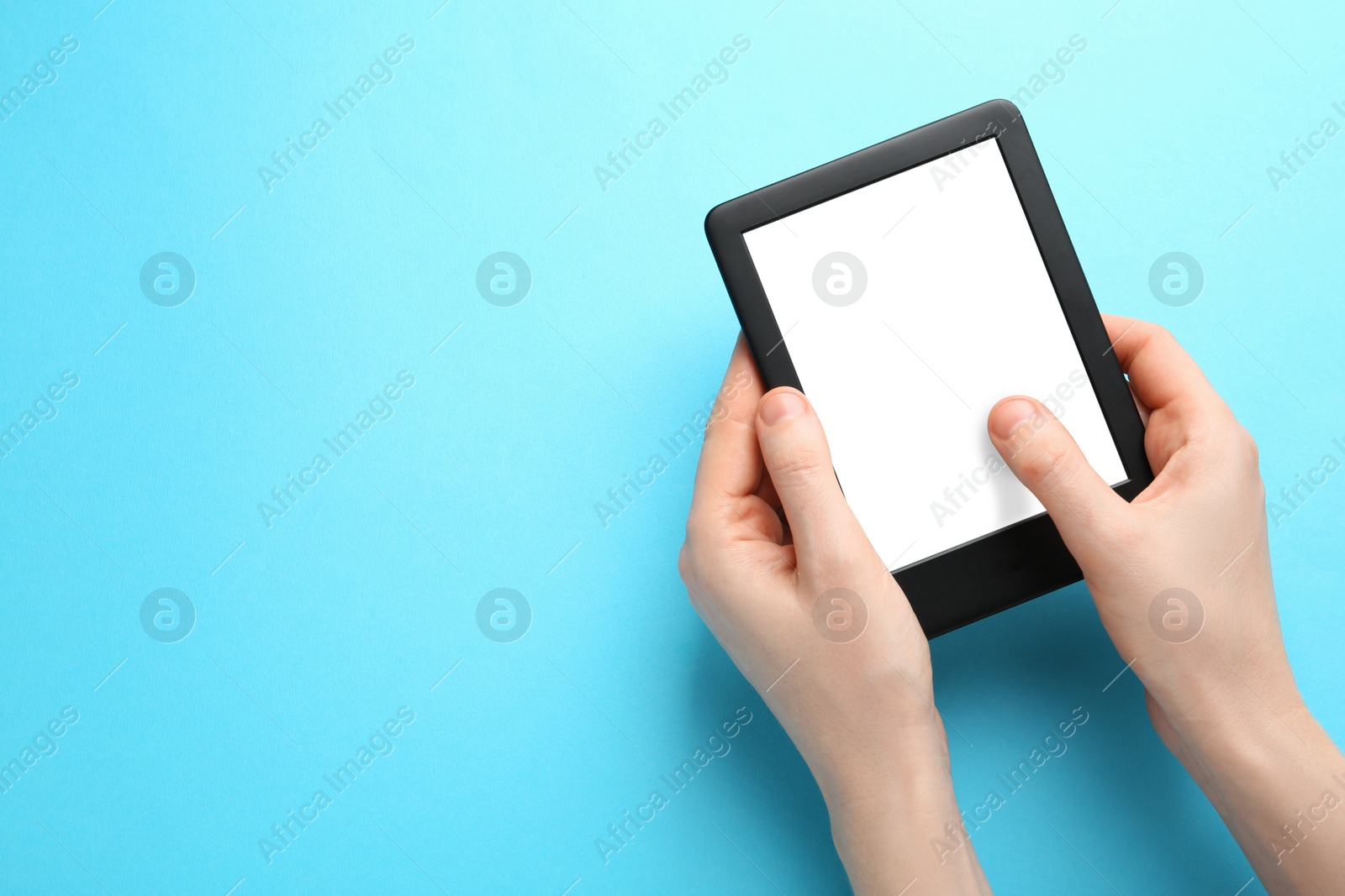 Photo of Woman using e-book reader on turquoise background, top view. Space for text