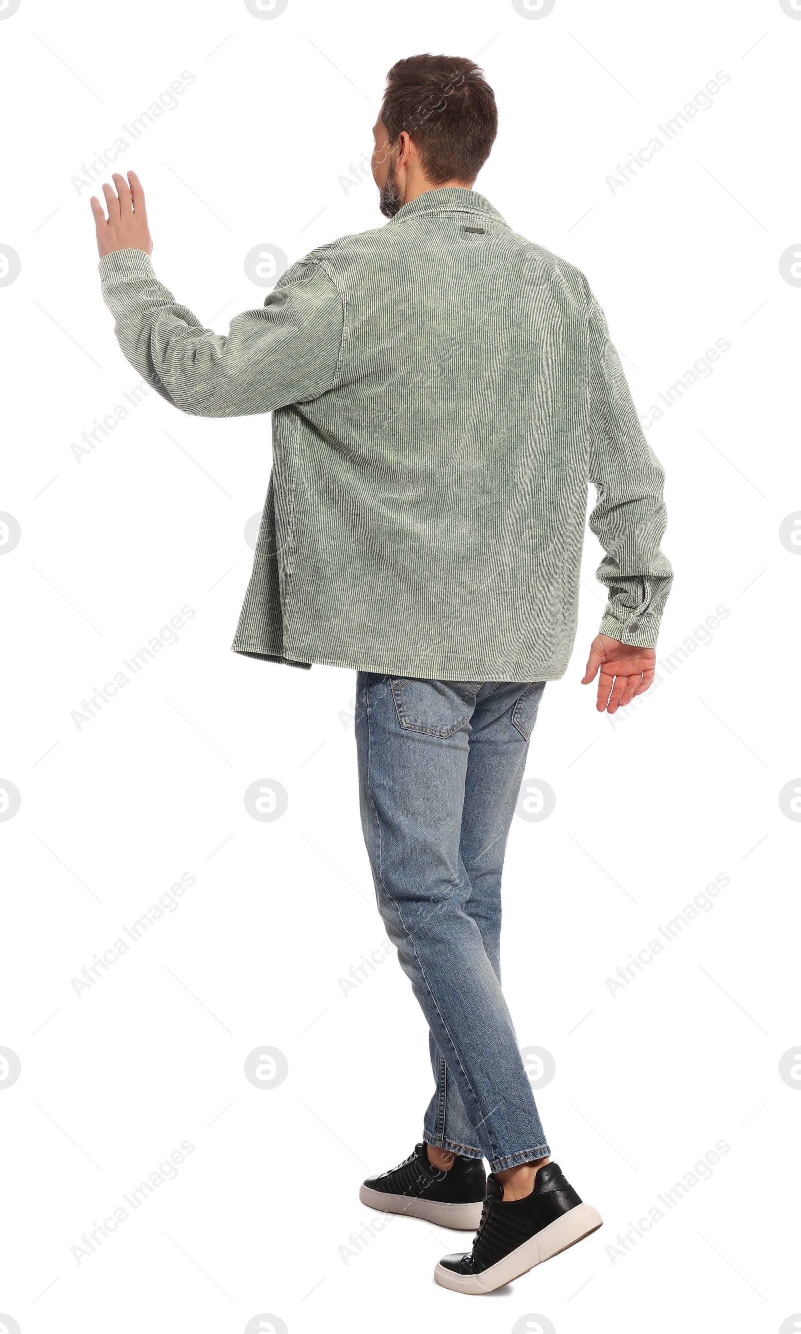 Photo of Man in stylish outfit walking on white background, back view