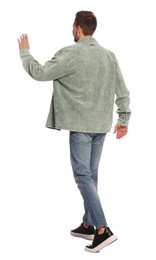 Photo of Man in stylish outfit walking on white background, back view