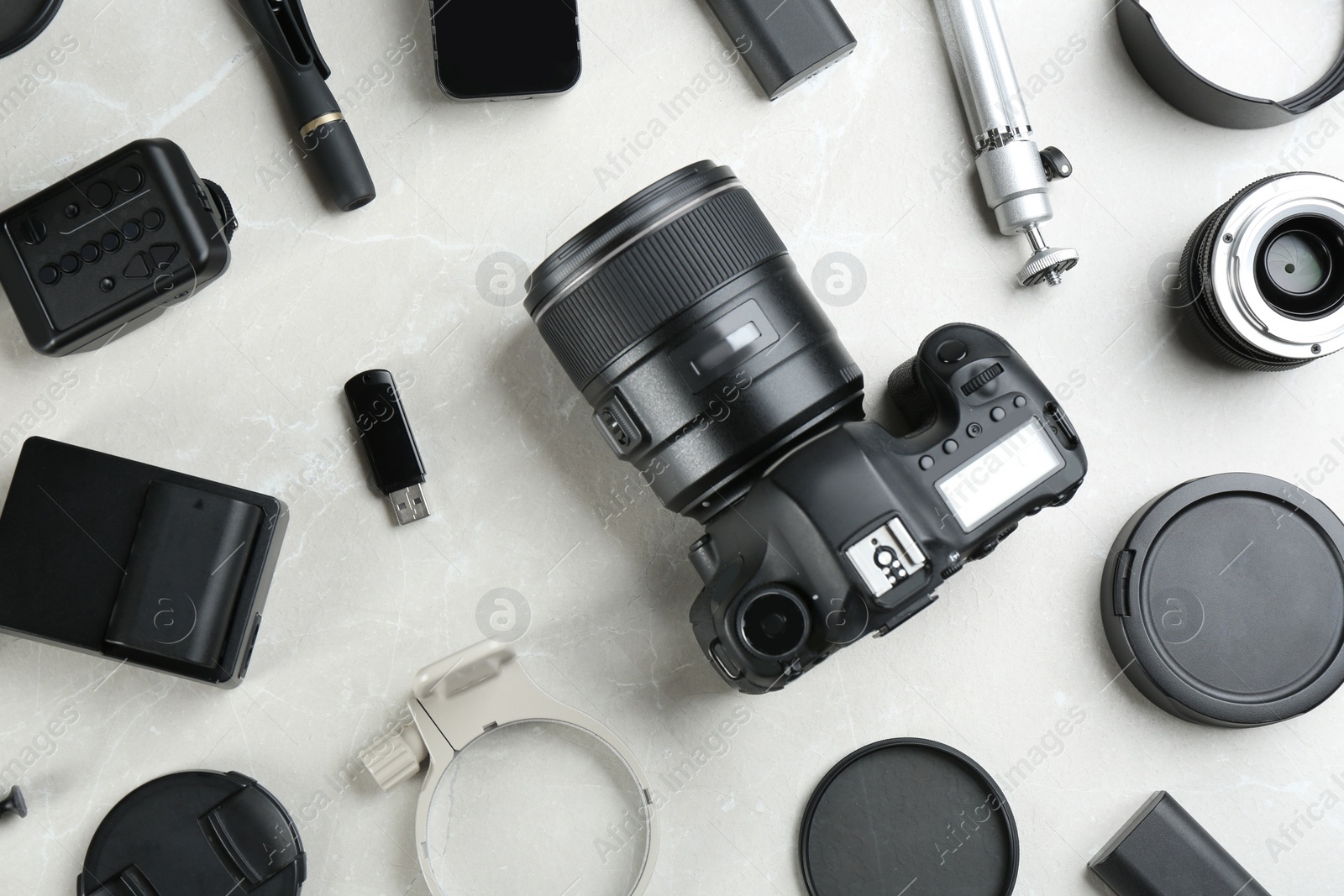 Photo of Flat lay composition with equipment for professional photographer on grey marble table