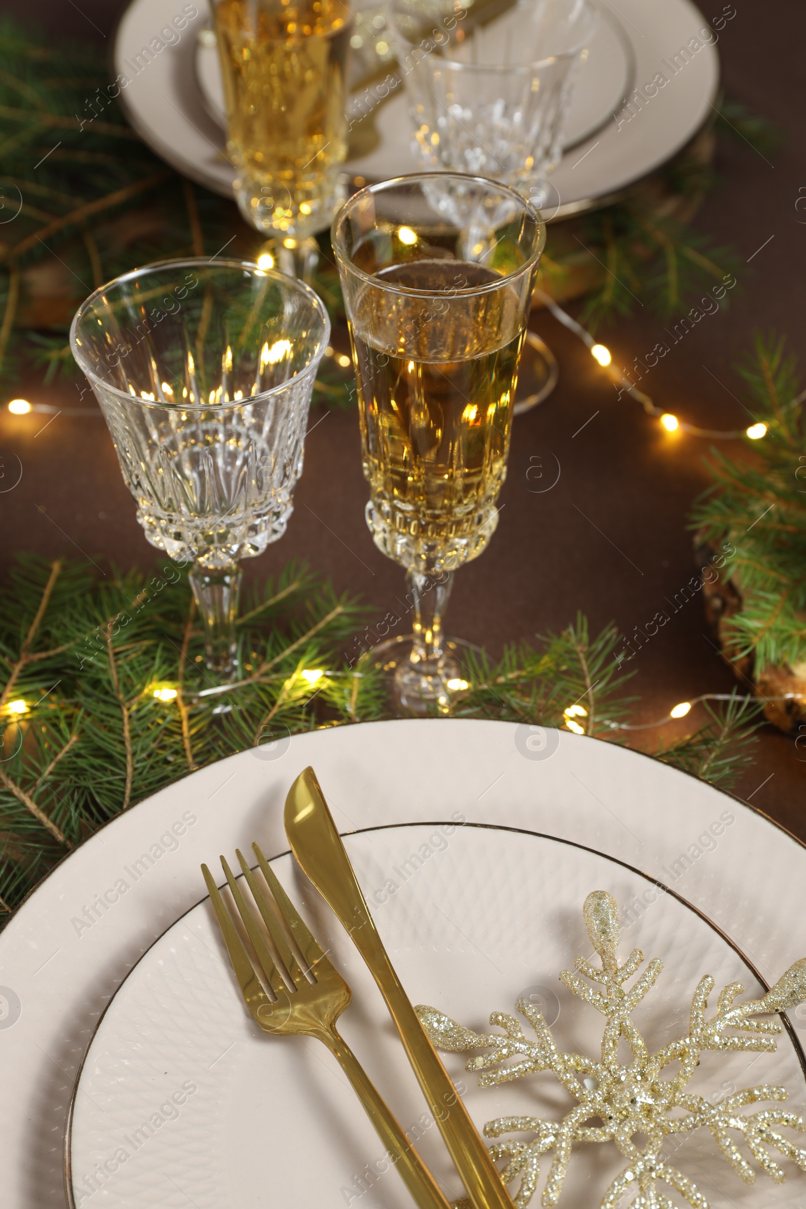 Photo of Table setting with festive lights and Christmas decor